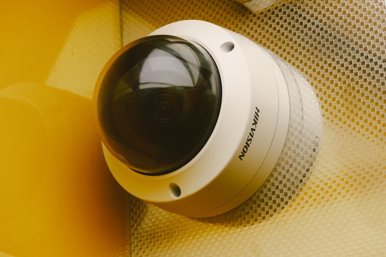 services-03 Close-up of a modern security camera installed indoors, ideal for surveillance.
